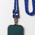 Eine Nahaufnahme einer grünen Handytasche, die an der LEY! Handykette - Blau-Orange, mit blauem und orangefarbenem Schlüsselband mit goldenen Metallakzenten, auf weißem Hintergrund. Das gewickelte Band liegt neben der Hülle.